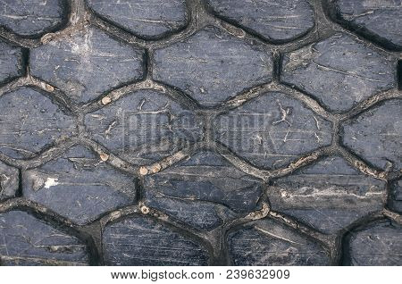 Old Car Tire Tread Texture Background. Worn Out Protector Of Car Tire. Used Wheels Close Up.
