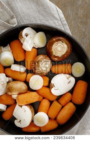 Stewing Cooking Healthy Food Concept. Cooking Healthy Vegetarian Food. Raw Carrots, Leek And Mushroo