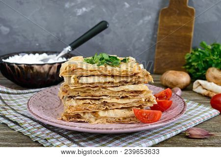 Pie, Casserole Pita With Mushrooms, Cottage Cheese And Cheese On A Plate On A Wooden Background. Lay