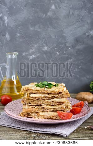 Pie, Casserole Pita With Mushrooms, Cottage Cheese And Cheese On A Plate On A Wooden Background. Lay