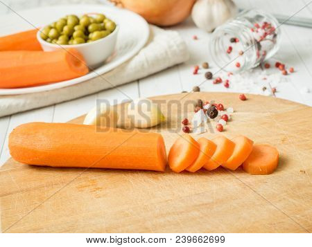 Sliced Carrots On The Table. Vegetables For Cooking Garlic Peas Onion Peppers