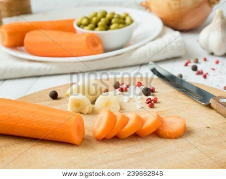 Sliced Carrots On The Table. Vegetables For Cooking Garlic Peas Onion Peppers