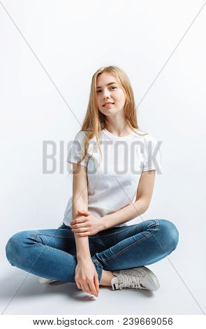 Young Girl Posing And Smiling, On A White Background Slender Blonde