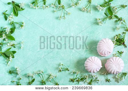Delicate Frame Of Marshmallows And Cherry Blossoms. Delicious Airy Dessert. Concept Of Light Air Des