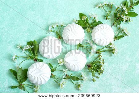 Delicate Vignette Of Marshmallows And Cherry Blossoms. Delicious Airy Dessert. Concept Of Light Air 