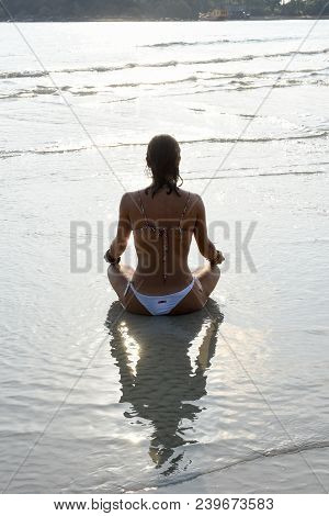 Girl Who Practices Yoga On The Beach