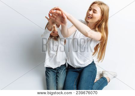 Mom And Little Daughter Looking At Each Other, Happy Family, Isolated Background, Cute And Beautiful
