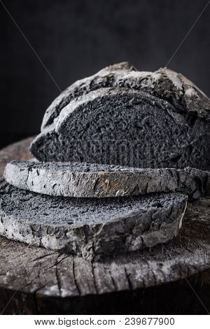 Homemade Rustic Bread And Slices Inusual Black Color On Dark Wood