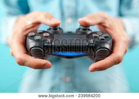 Male hands holding a PS4 controller