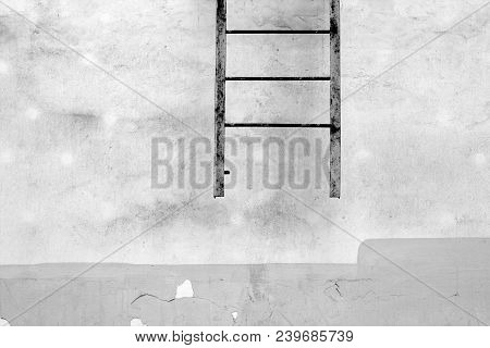 Fire Escape Ledder On Cement Wall In Black And White. Urban Background And Texture.