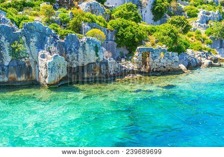 The Stone Ruins Of Ancient Sunken Settlement On The Coast Of Kekova Island, Turkey.