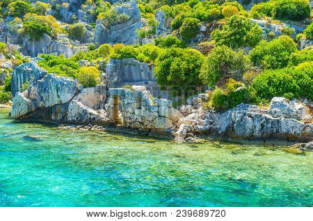 Indented Rocky Coast Of Kekova Island With Preserved Ruins Of Ancient Sunken City Among The Lush Gre