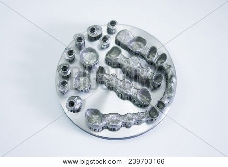 Object Printed On Metal 3d Printer Isolated. Dental Crowns Created In A Laser Sintering Machine Clos
