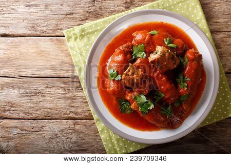 Italian Food: Beef Steak Stuffed With Parsley And Parmesan Cheese In Tomato Sauce Close-up On A Plat