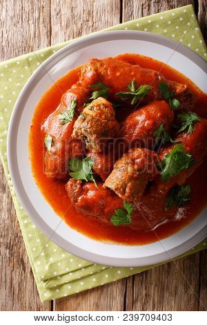 Delicious Beef Steak Stuffed With Parsley And Parmesan Cheese Stewed In Tomato Sauce Close-up. Verti