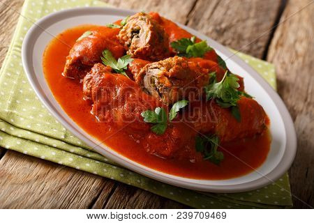 Italian Food: Beef Steak Stuffed With Parsley And Parmesan Cheese In Tomato Sauce Close-up On A Plat