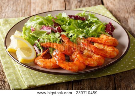 Fried Prawns With Honey And Soy Sauce And Fresh Leaf Salad Close-up On A Plate. Horizontal