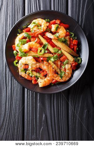 Portion Of Spicy Shrimp With Pepper, Garlic, Corn Cob And Herbs Close-up. Vertical Top View