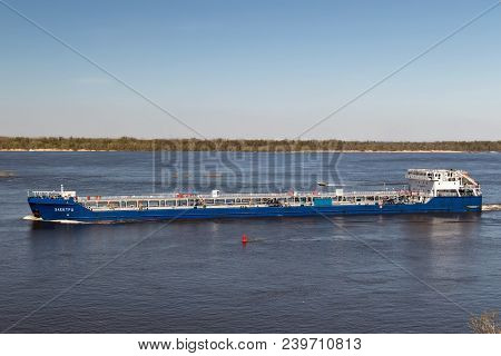 The Barge For Transportation Of Oil Products Turns From The Riverbed Of The Volga Near The Lighthous