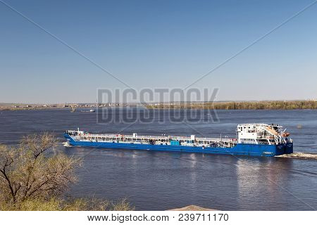 The Barge For Transportation Of Oil Products Turns From The Riverbed Of The Volga Near The Lighthous