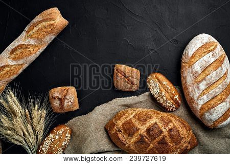 Bakery - Gold Rustic Crusty Loaves Of Bread And Buns On Black Chalkboard Background. Still Life Capt