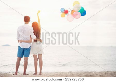 Couple In Love Stand On Beach With Bolloon And Romantic Valentine Concept