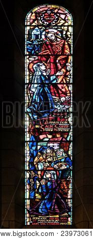 PARIS, FRANCE - JANUARY 08, 2018: Scenes from the life of Saint Margaret Mary Alacoque, stained glass window in Basilica of the Sacre Coeur, dedicated to the Sacred Heart of Jesus in Paris, France.