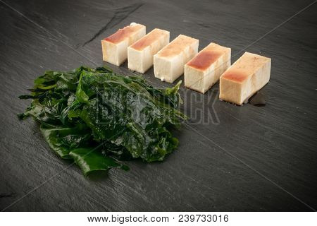 Wakame Seaweed On Natural Stone Background. Healthy Algae Food With Soy Sauce And Tofu