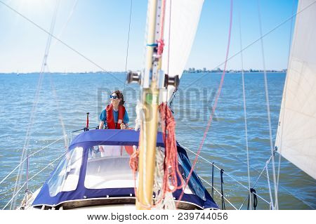 Young Man Sailing. Teenager Boy On Sea Sail Boat.