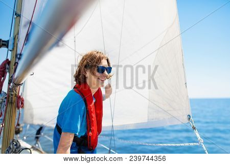 Young Man Sailing. Teenager Boy On Sea Sail Boat.
