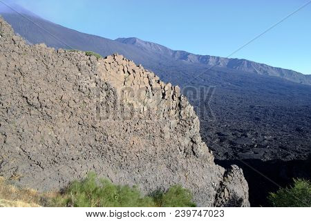 rock face and lava flow cooled in Bove Valley of Etna Park, Sicily