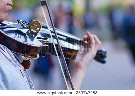 The Violin Is Big, Against The Backdrop Of The Street