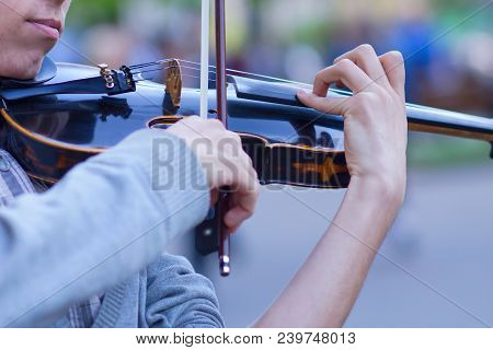 The Violin Is Big, Against The Backdrop Of The Street