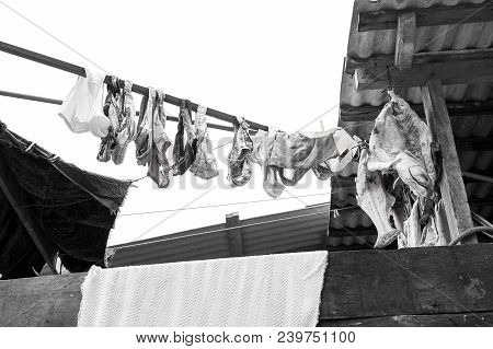 Laundry And Fish Drying In Air On White Sky Background In Boca De Valeria, Brazil. Washing And Fishi