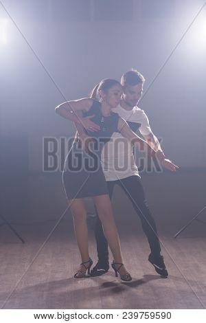 Young Couple Dancing Social Danse Kizomba Or Bachata Or Semba Or Taraxia In Dancing Class Background