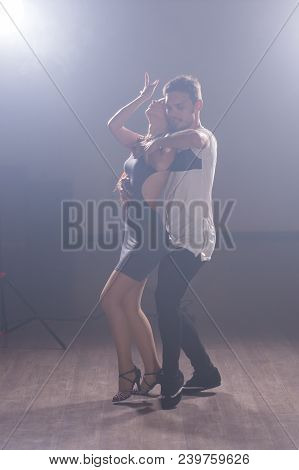 Young Couple Dancing Social Danse Kizomba Or Bachata Or Semba Or Taraxia In Dancing Class Background