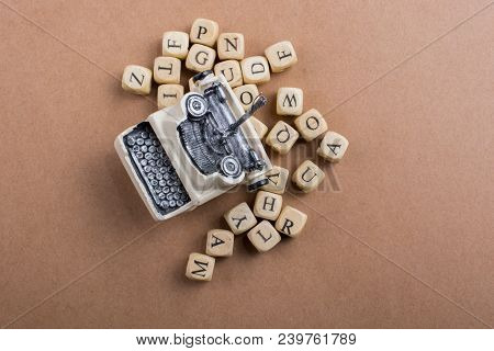 Letter Cubes Of Made Of Wood Around Model Typewritter