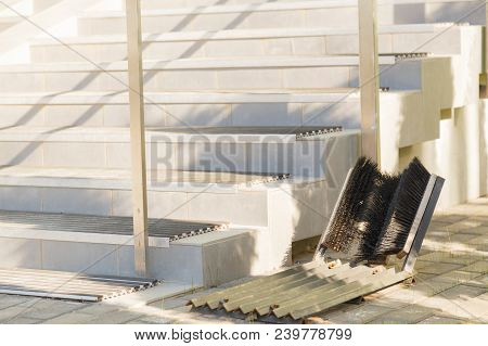 Entrance Of A House With Typical Outdoor Shoe Cleaning Brushes.