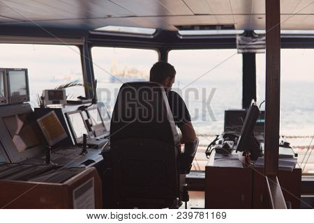 Deck Navigation Officer On The Navigation Bridge. He Looks At Radar Screen. Watchkeeping, Collision 