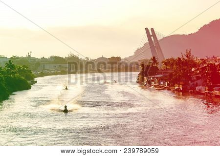 Marapendi Lagoon Seen From Above With Houses On The Hill During Sunset, Golden Light. Jet Skis Are R