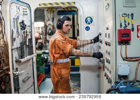 Marine Engineer Officer Controlling Vessel Engines And Propulsion In Engine Control Room Ecr. Ship M
