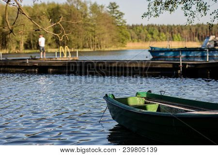 Fish Fishing At A Lake In Central Europe. Anglers Fishing On The Pier.