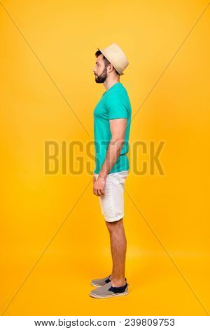 Vertical Side Profile View Of Male Snap Model Isolated On Bright Yellow Background, He Is Wearing Su