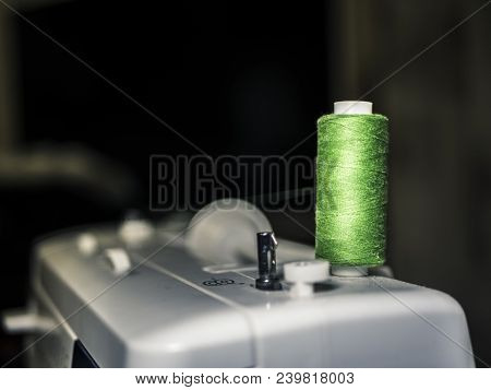 Colourful Thread Spool On Top Of Sewing Mahine