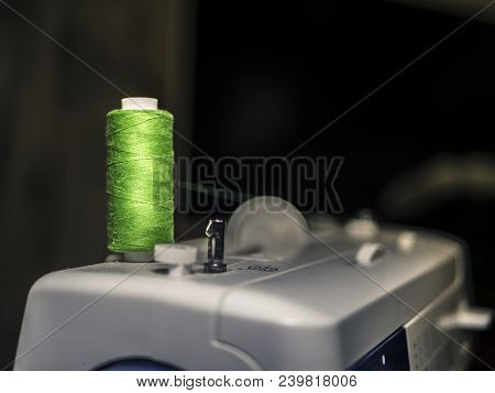 Colourful Thread Spool On Top Of Sewing Mahine