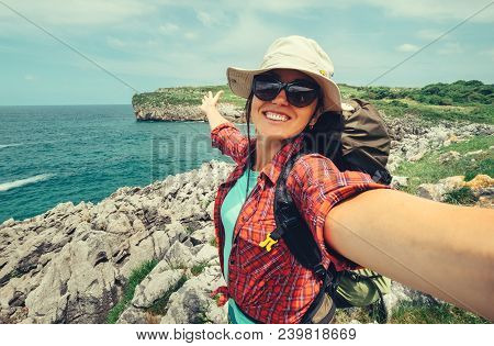 Happy Woman Backpacker Traveler Take A Selfie Photo On Amazing Ocean Coast