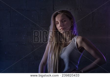 Portrain Of The Girl In The White Shirt With Water Drop In A Dark Room Illuminated By Light During A
