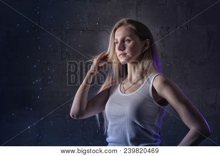 Portrain Of The Girl In The White Shirt With Water Drop In A Dark Room Illuminated By Light During A