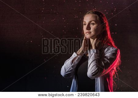 Portrain Of The Girl In The White Shirt With Water Drop In A Dark Room Illuminated By Light During A