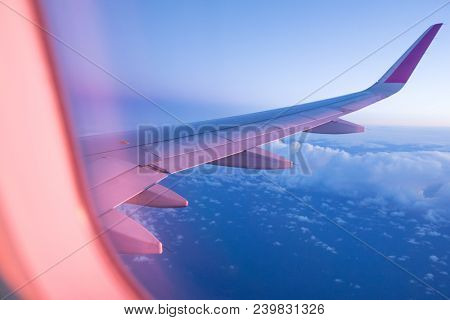 Sunset sky with beautiful clouds from the airplane window
